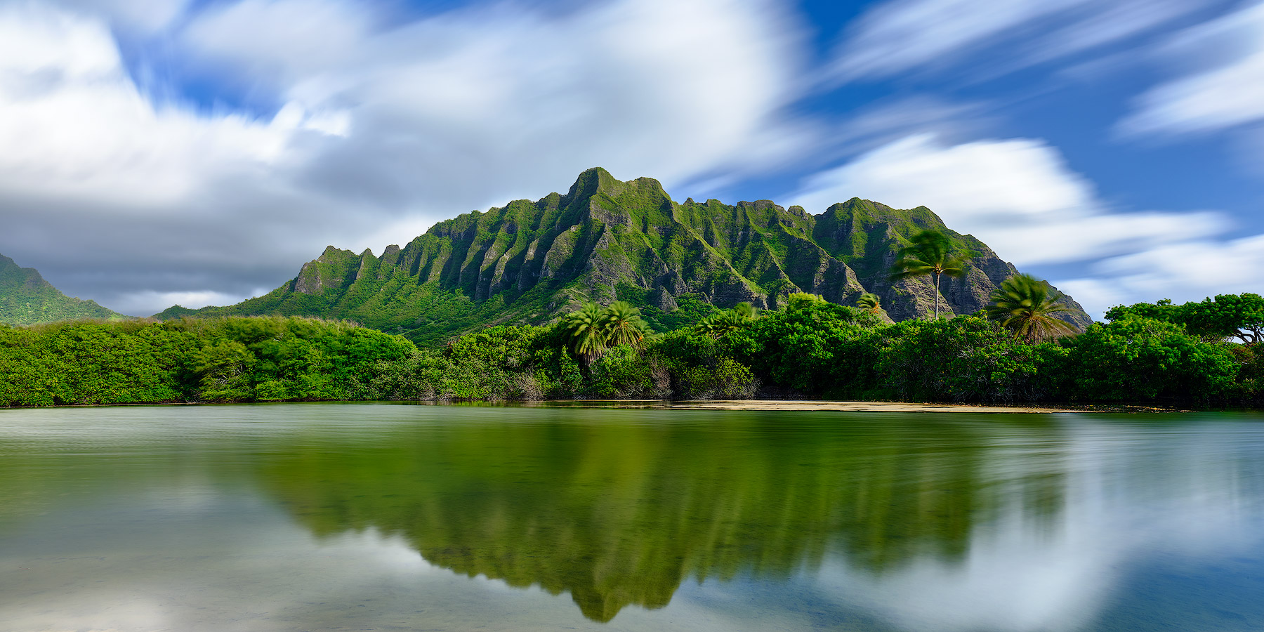 a long exposure photograph of the beautiful Kualoa range on the island of Oahu.  Oahu landscape photography by Hawaii photographer Andrew Shoemaker