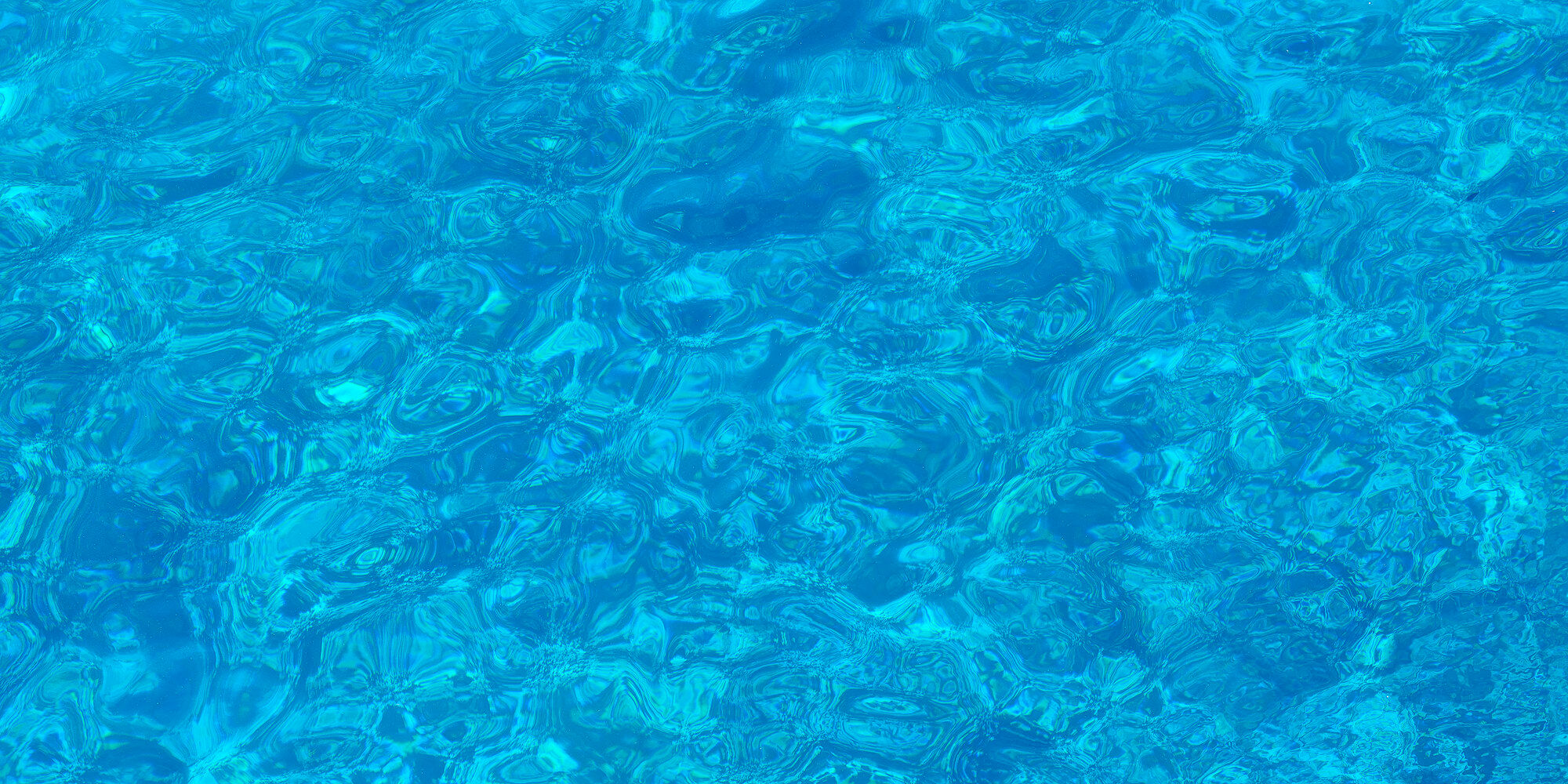 Mesmerize is an abstract water photography captured at Molokini crater on the island of Maui showcasing the crystal clear waters of the crater.