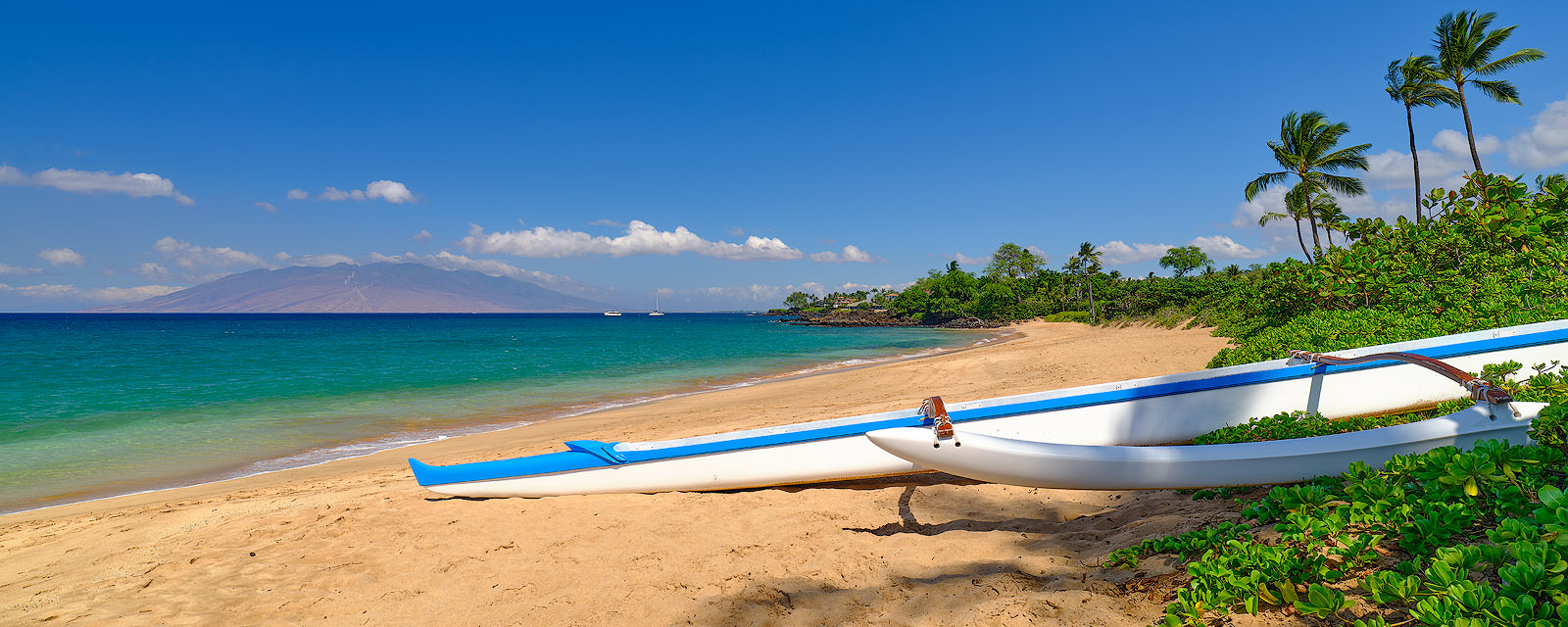 No Bad Days A Hawaiian outrigger canoe in the foreground of the beautiful Maluaka Beach in Makena on the island of Maui, Hawaii. Fine art nature photography prints