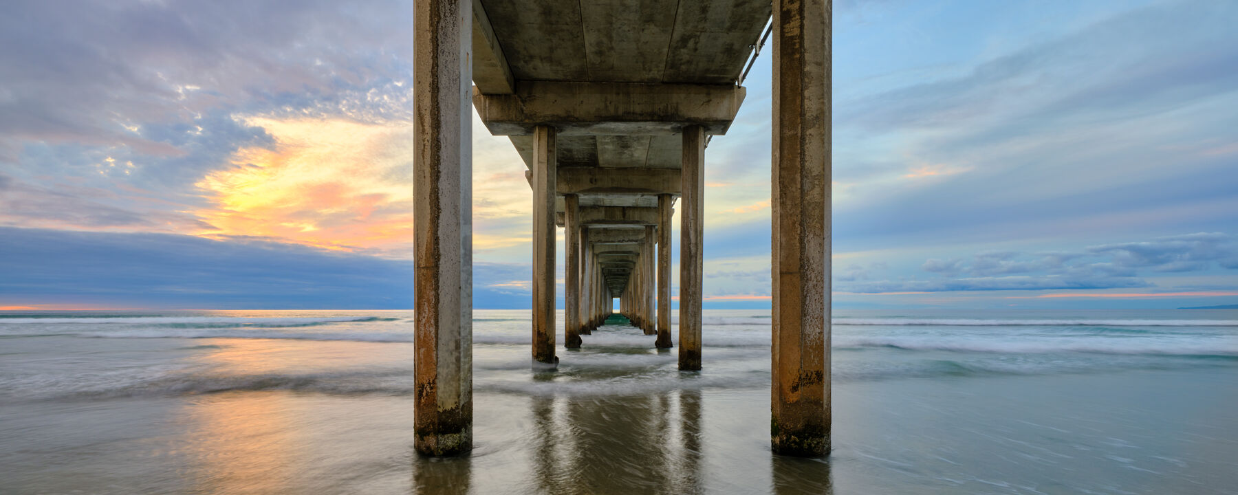 a panoramic image looking down the beautiful Scripps Pier in La Jolla, California.  California Fine Art Landscape photography by Andrew Shoemaker