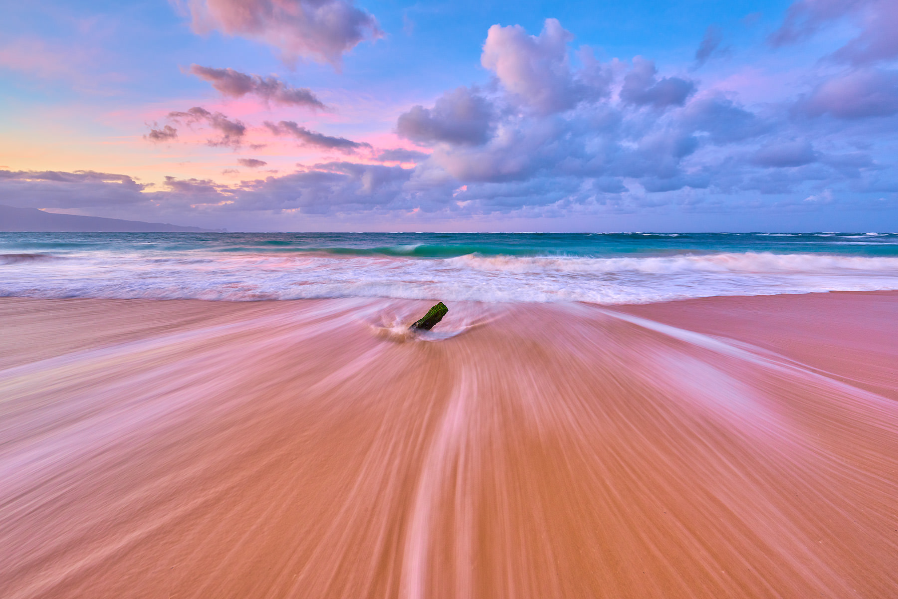 a photograph of a north shore Maui beach scene at Baldwin in Paia with the outgoing waves and pastel colors at sunrise.  Hawaii photography by Andrew Shoemaker