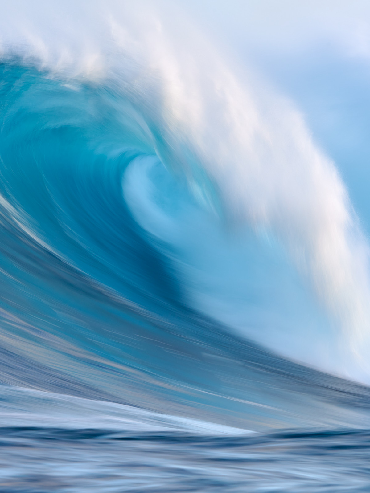 a vertical long exposure photograph of the biggest wave in Hawaii Jaws on the north shore of the island of Maui.