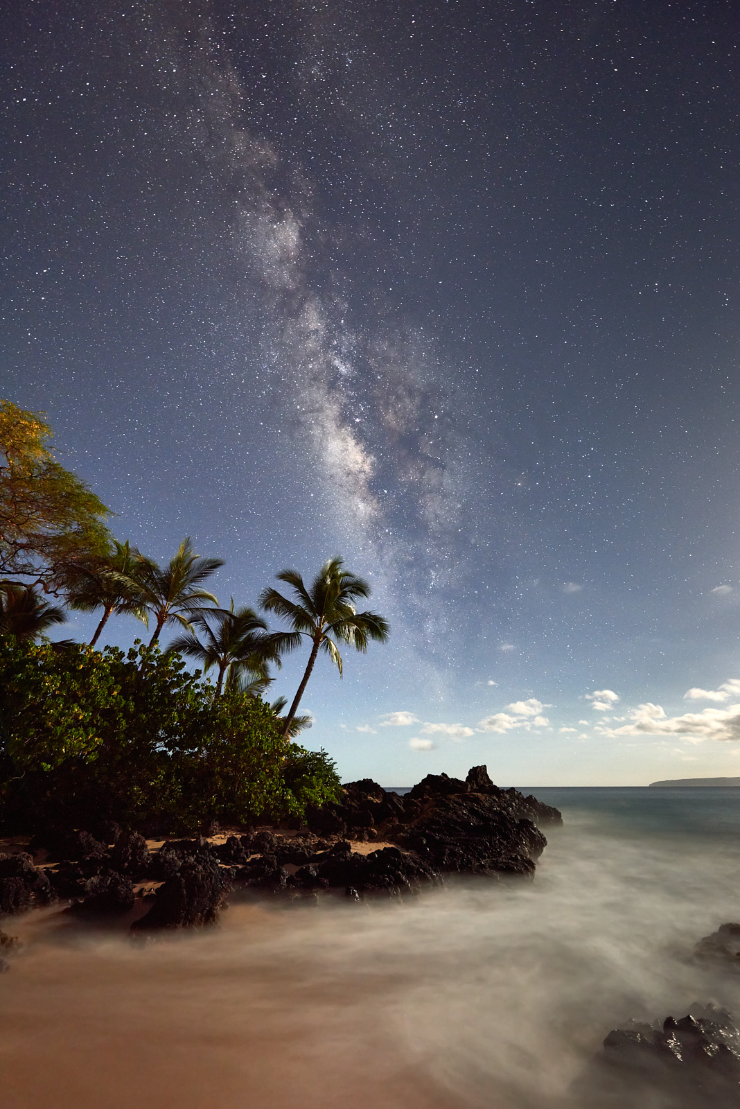 Secret Cosmos The Milky Way Galaxy rises over Secret Beach in Makena on the island of Maui. The moon low on the horizon provides lighting for the foregound. MIlky Way Photo