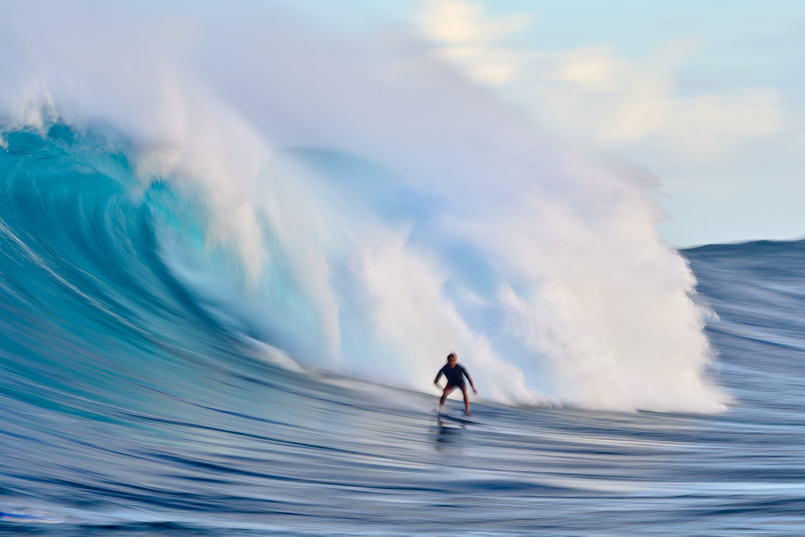 a slow motion capture of surfer Kai Lenny surfing Jaws on Maui