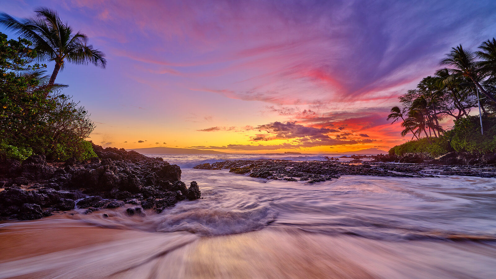 Silver Lining pink, purple and magenta sunset panoramic photograph at secret beach in Makena on the island of Maui
