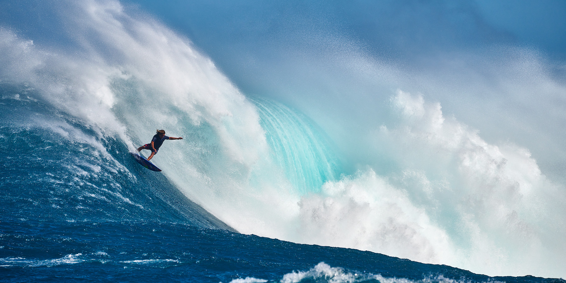 famous big wave surfer Kai Lenny surfing Jaws (Peahi) on the north shore of Maui showing the size and scale of this giant wave.  Hawaii Wave Photography 