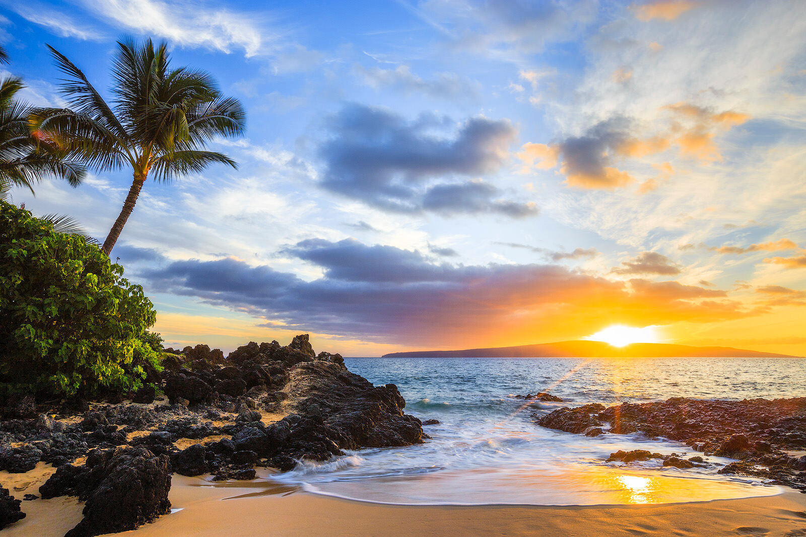 sunset of the left cove at secret beach on Maui in Makena