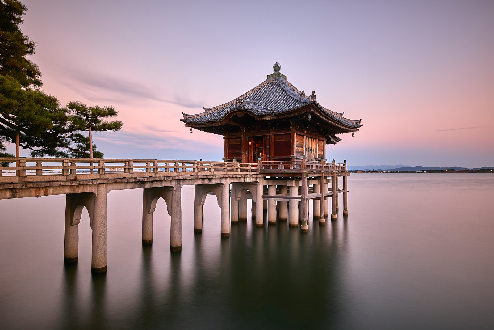 a long exposure of a floating temple with a bridge going out to at Ukimodo temple in Kyoto, Japan