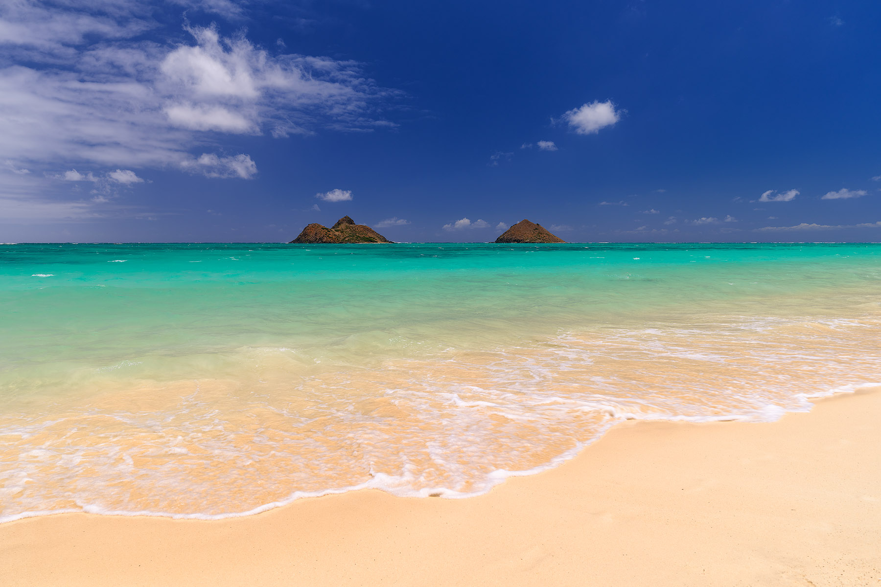 Windward Paradise daytime photograph of the beautiful Lanikai Beach on the Hawaiian island of Oahu with white sand, amazing turquoise water color and the Mokulua islands